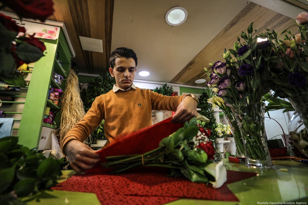 Palestinian shop keeper is seen at a souvenir market ahead of the Valentine's Day in Gaza City on 13 February 2019 [Mustafa Hassona/Anadolu Agency]