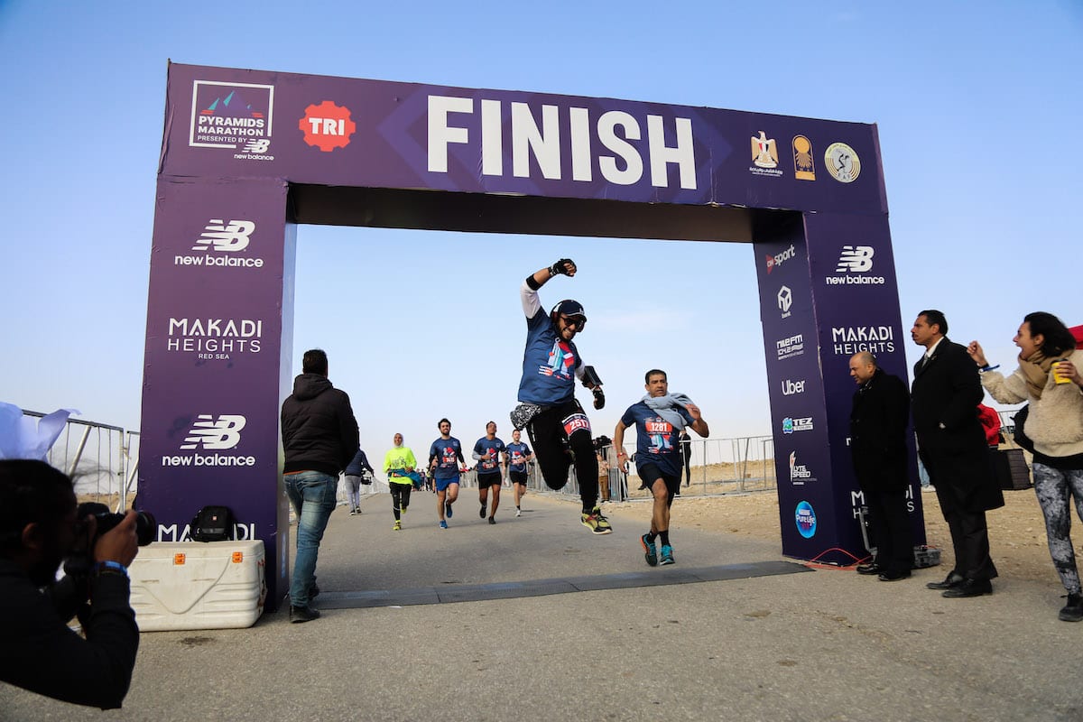 Some people reach the finish line as other people gather attend a public run with the attendance of four thousands people from different countries, around the Great Pyramid of Giza, which is located in the western part of capital city Cairo, in Egypt on 15 February 2019. [Ahmed Al Sayed - Anadolu Agency]