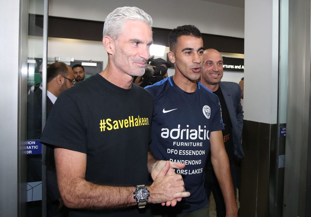 Refugee Bahraini footballer Hakeem al-Araibi walks with Craig Foster, former Australian football captain and commentator as he arrives at Melbourne Airport on 12 February 2019 in Melbourne, Australia. [Scott Barbour/Getty Images]