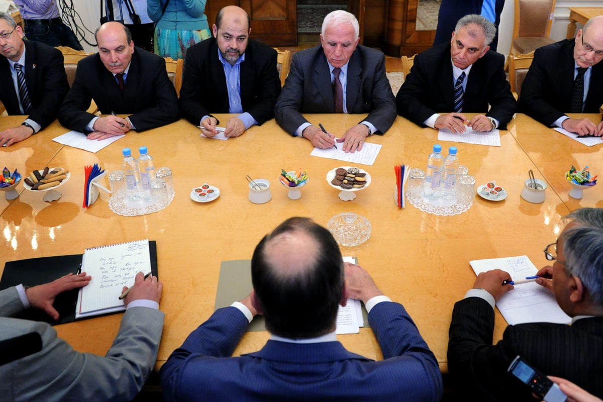 Russian Foreign Minister Sergei Lavrov (foreground-C) meets with Fatah member Azzam al-Ahmed (Backround 3-R) Mussa Abu Marzuk of Hamas (Background 3-L) , and Maher al-Taher (Background 2-L) of the Popular Front for the Liberation of Palestine and other members of the Plestinian delegation during their meeting in Moscow on 23 May 2011. [ALEXANDER NEMENOV/AFP/Getty Images]