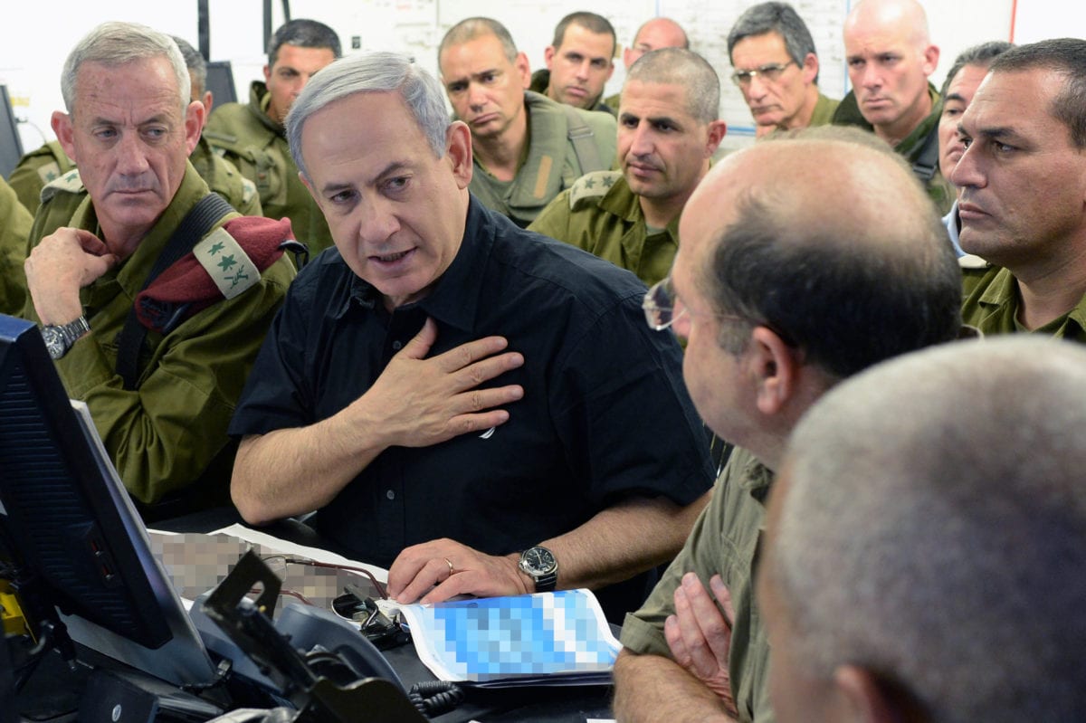 Israeli Prime Minister Benjamin Netanyahu (C), and IDF Chief of Staff Benny Gantz (L) visit a tactical headquarters of the IDF in southern Israel near the border with Gaza on July 21, 2014 in near Beersheba, Israel. [Kobi Gideon/GPO via Getty Images]