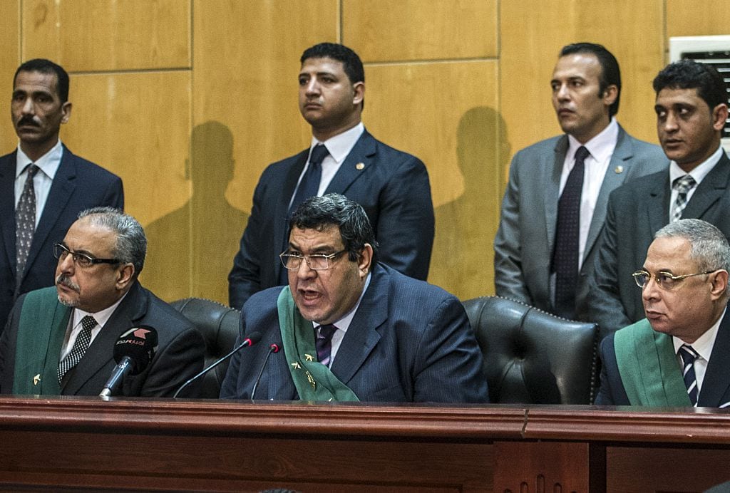 Egyptian judge Shaban el-Shamy (C) reads out the verdict sentencing deposed Islamist president Mohamed Morsi and more than 100 other defendants to death at the police academy in Cairo on 16 May 2015. [KHALED DESOUKI/AFP/Getty Images]