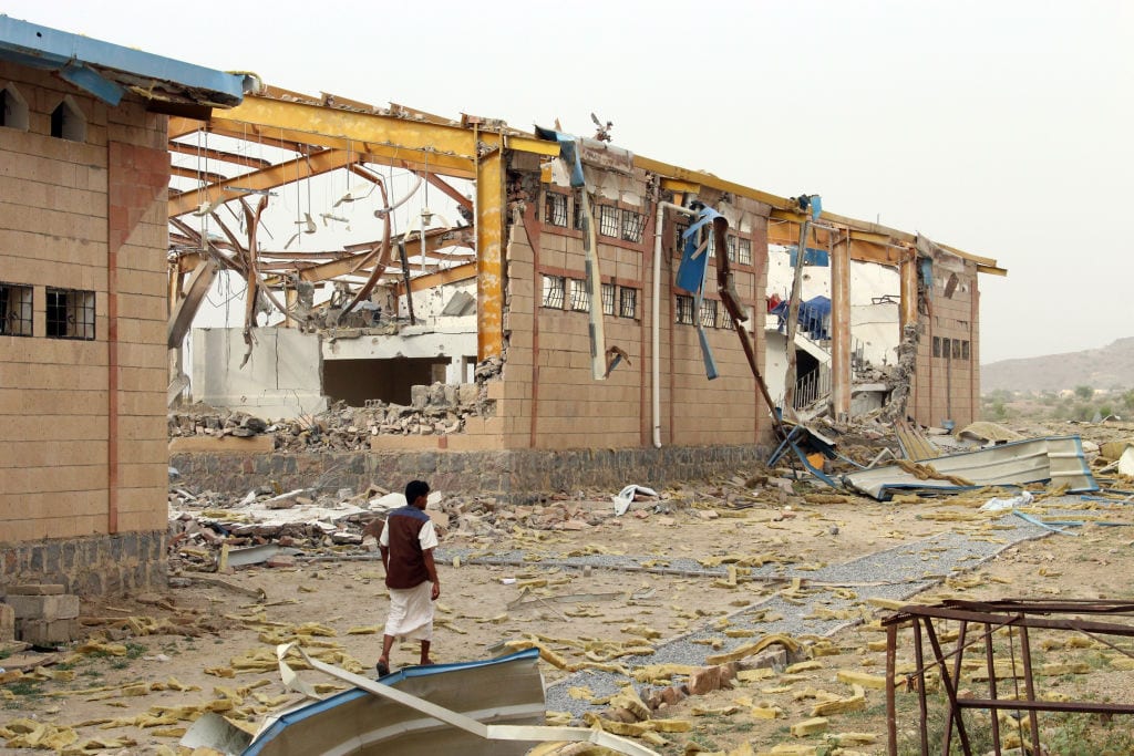 A Yemeni man inspects the damage caused by a Saudi-led air strike on a cholera treatment centrer supported by Doctors Without Borders (MSF) in the Abs region of Yemen on 11 June 2018. [ESSA AHMED/AFP/Getty Images]