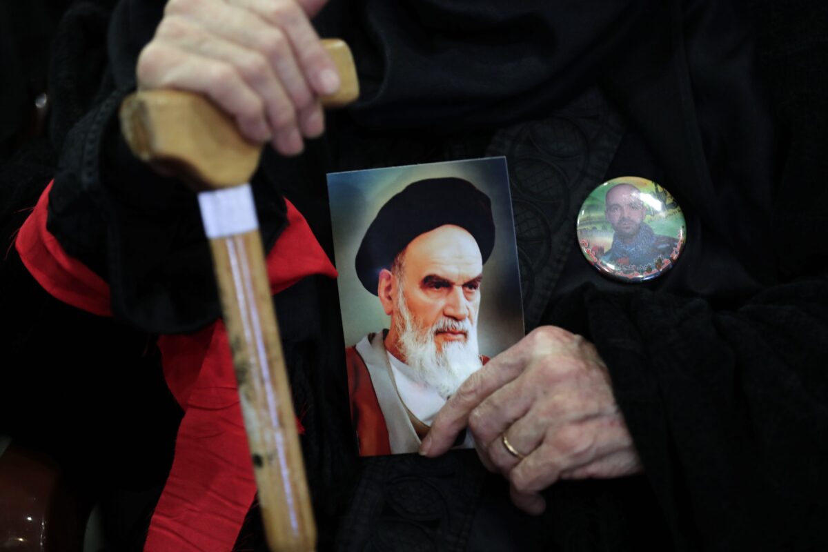 A supporter of Lebanon's Shia movement Hezbollah holds an image of Iran's late founder of the Islamic Republic, Ayatollah Ruhollah Khomeini, during celebrations marking the 40th anniversary of the Iranian revolution in the capital Beirut's southern suburbs on February 6, 2019. [ANWAR AMRO / AFP/ Getty]