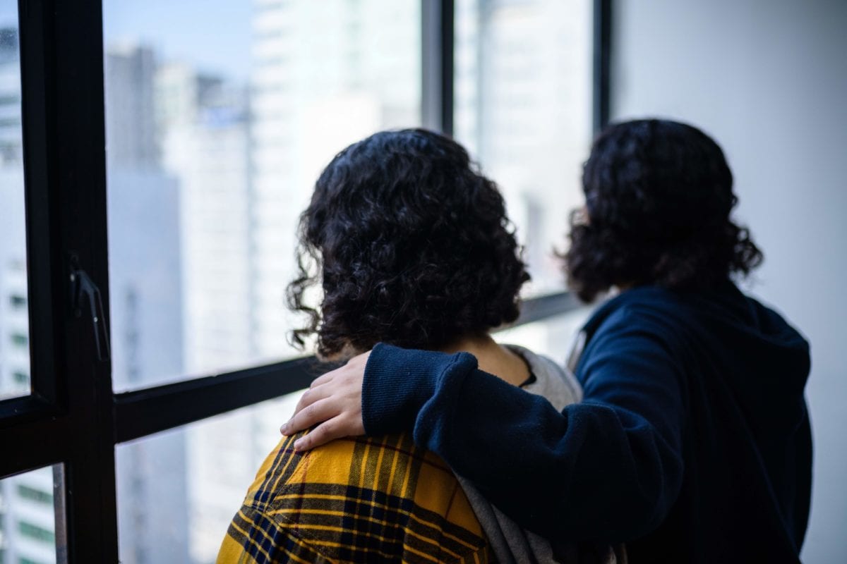 Saudi sisters Rawan (in yellow), 18, and Reem, 20, (both using adopted aliases) stand next to each other during an interview with AFP in Hong Kong on February 22, 2019. [ANTHONY WALLACE/AFP/Getty Images]