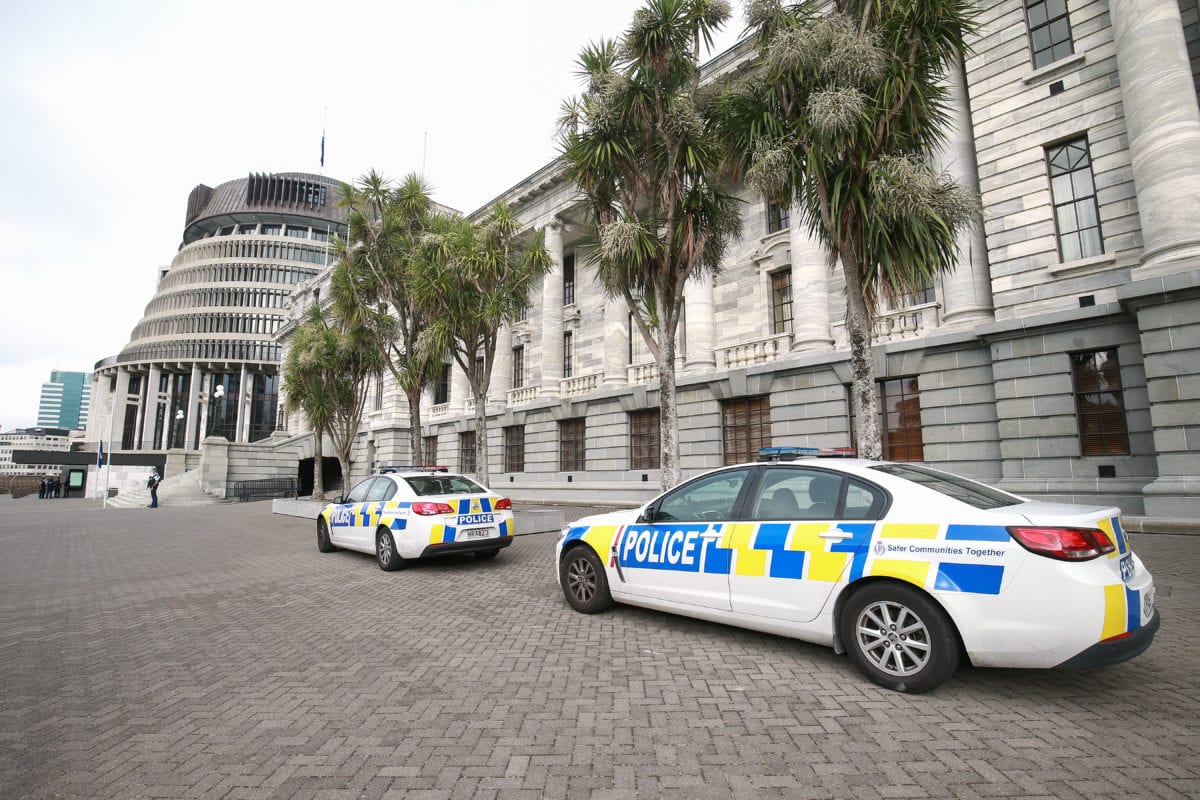 Police cars parked outside Parliament on March 18, 2019 in Wellington, New Zealand. Prime Minister Jacinda Ardern said 'our gun laws will change' in a press conference following attacks on two Christchurch mosques that killed 50 people on Friday, March 15. [Hagen Hopkins/Getty Images]