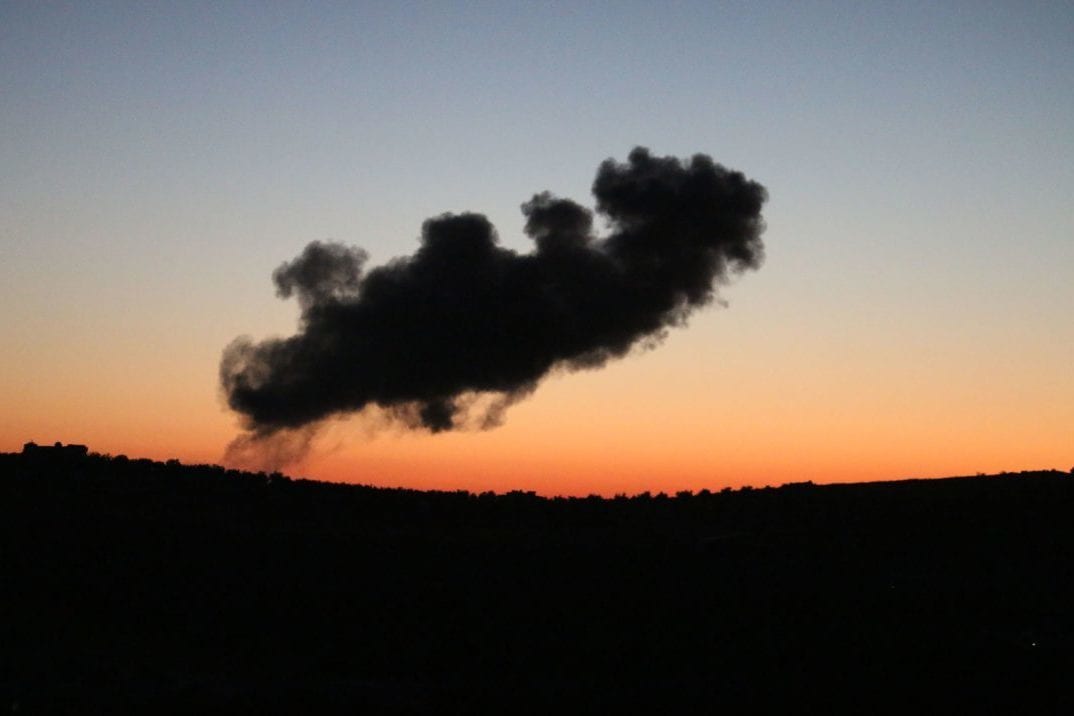 Smoke rises above rebel-held areas of the city of Daraa during reported airstrikes by Syrian regime forces on 8 July 2018. [AFP/Getty]