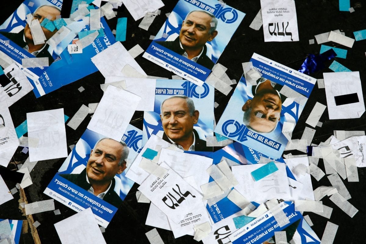This picture taken early on April 10, 2019 shows Israeli Likud Party campaign material and posters of Prime Minister Benjamin Netanyahu strown on the floor following election night at the party headquarters in the coastal city of Tel Aviv. (Photo by Jack GUEZ / AFP / Getty)
