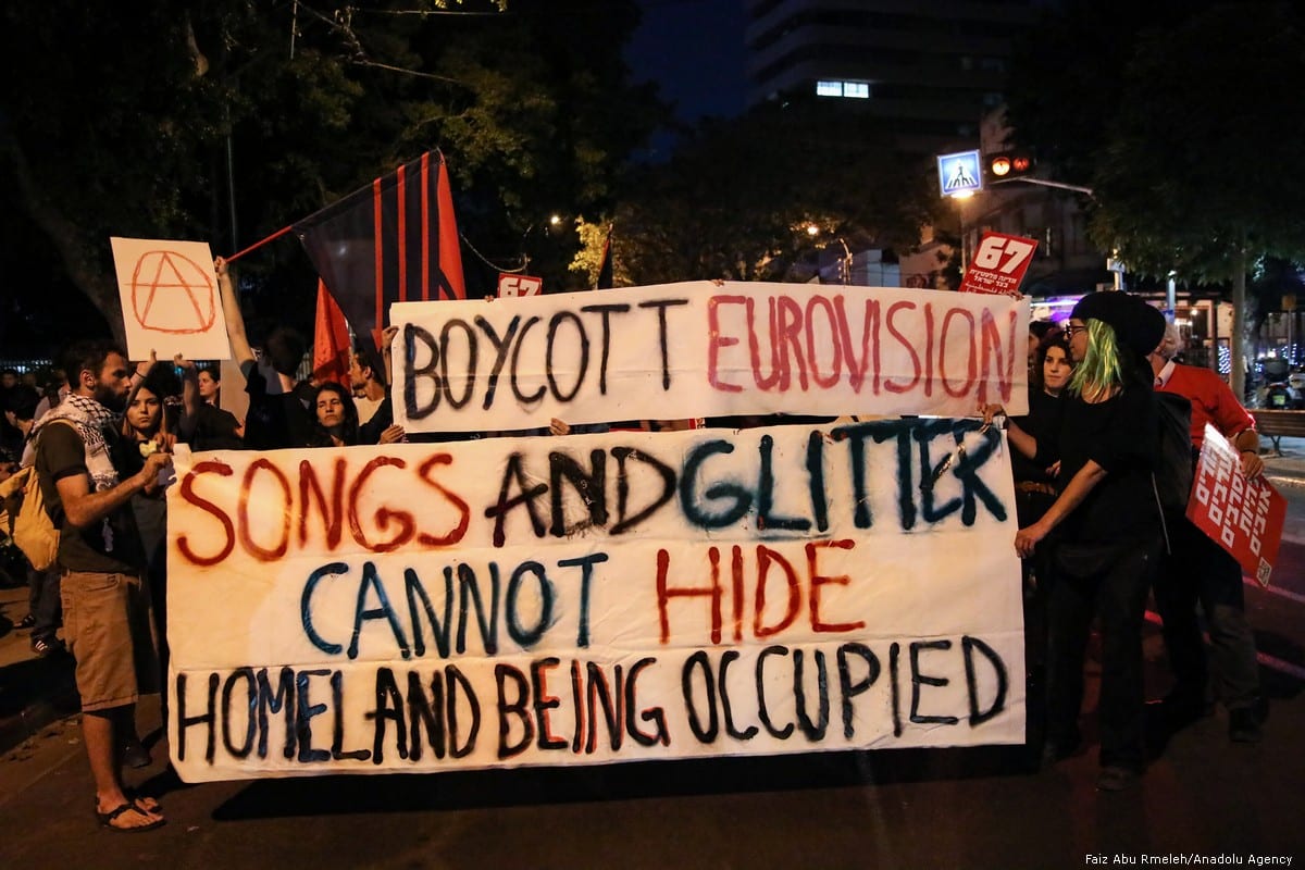 People hold placards during a protest against the Eurovision Contest demanding the removal of Israel's blockade on Gaza in Tel Aviv on 14 May 2019 [Faiz Abu Rmeleh/Anadolu Agency]