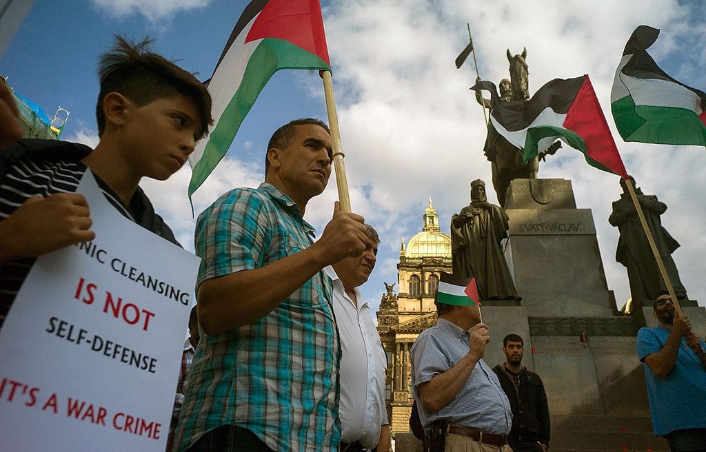Pro-Palestinian protesters holding banners and Palestinian flags attend a rally in solidarity with Palestinians killed in Israeli assaults in Gaza on July 24, 2014 in Prague. [MICHAL CIZEK/AFP/Getty Images]