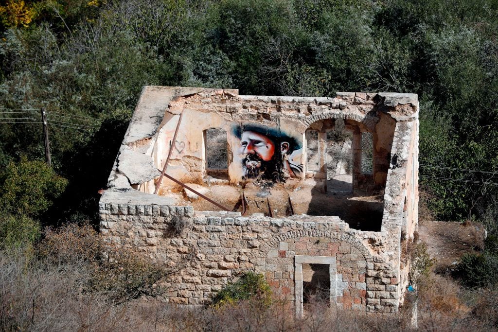 An old house is seen in the Palestinian village of Lifta which was abandoned during fighting in the 1948 Arab-Israeli war, on the outskirts of Jerusalem, on 20 October, 2017 [THOMAS COEX/AFP/Getty Images]