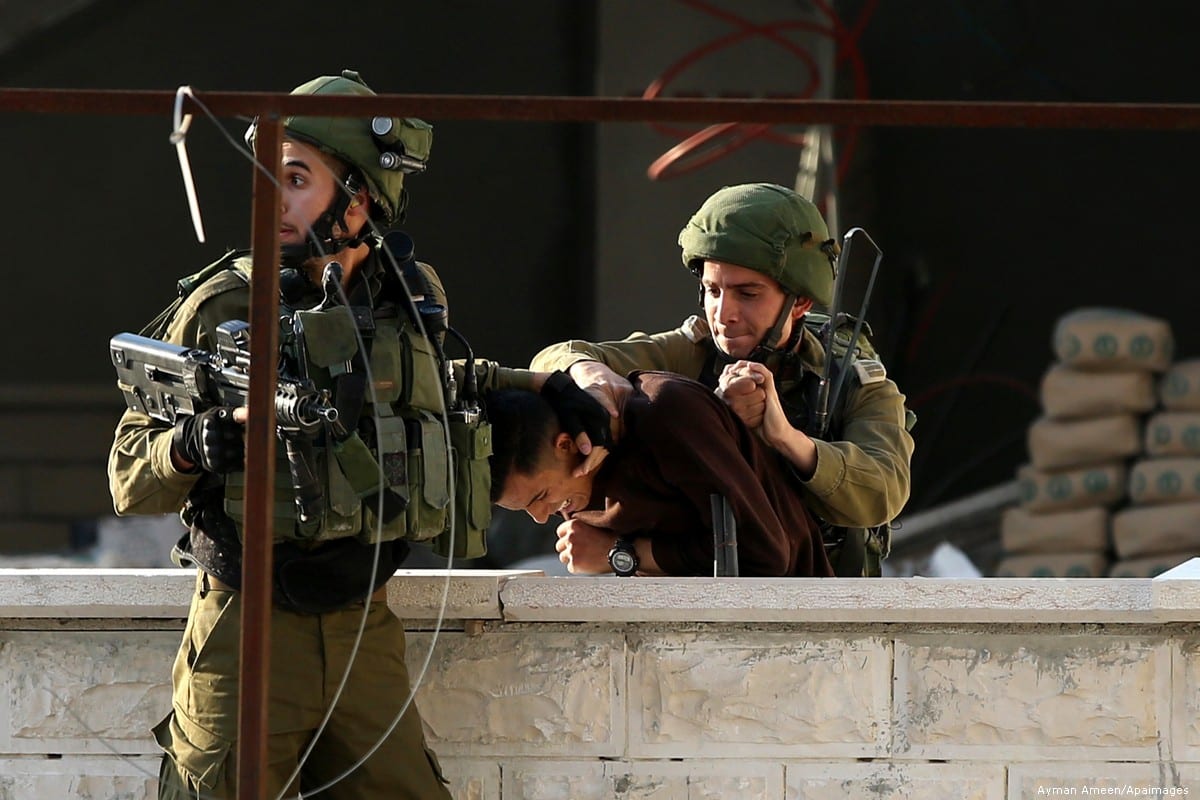 Israeli security forces arrest a Palestinian in the West Bank, on 15 December 2018 [Ayman Ameen/Apaiamges]