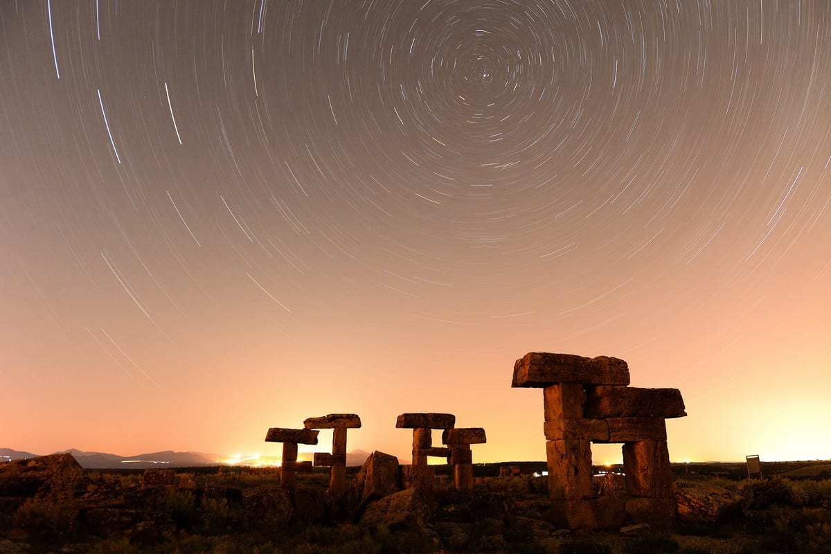 Starlight trails in the night sky over the ruins at Blaundus in Ulubey, Turkey on 3 July 2019 [Soner Kılınç/Anadolu Agency]