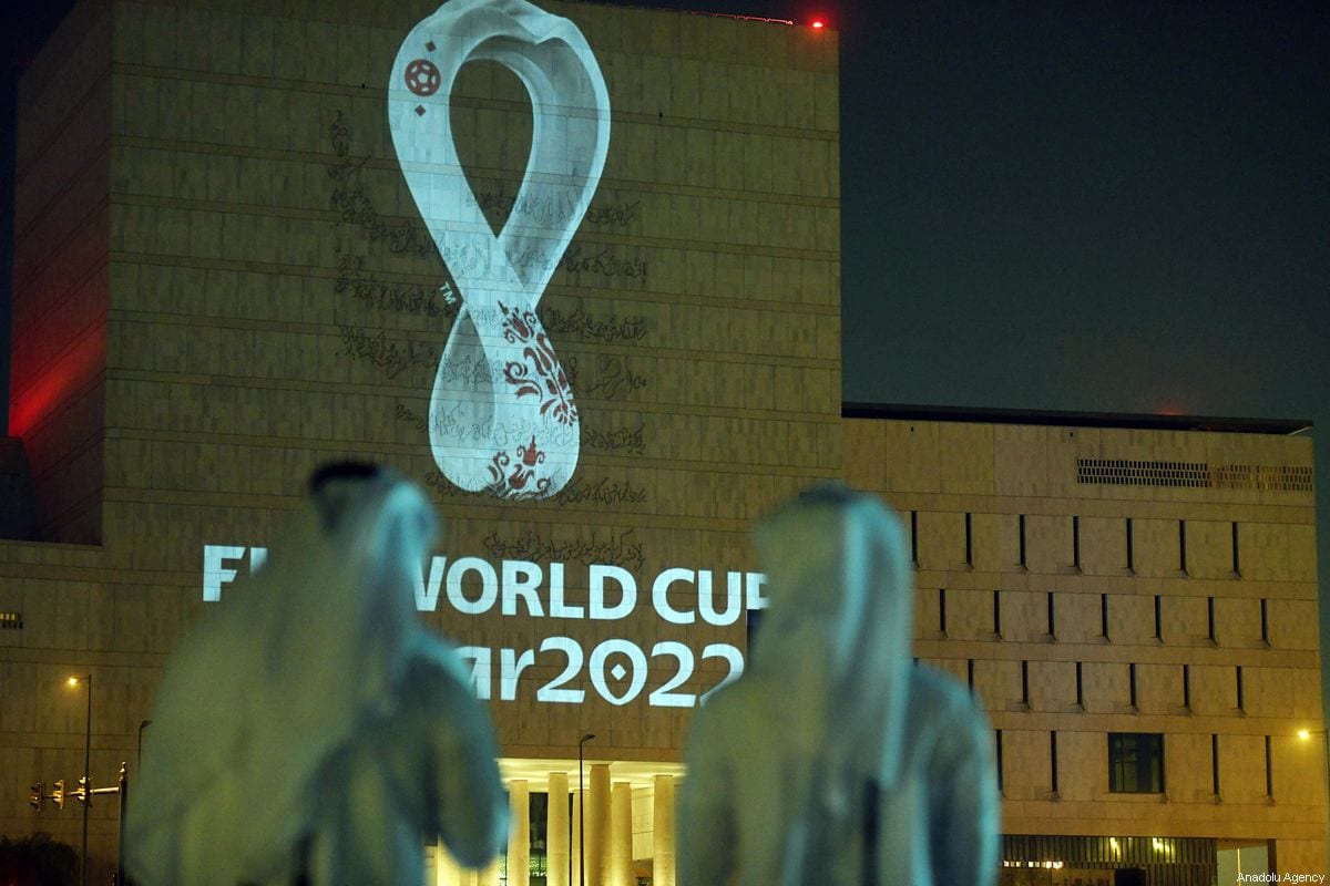 The official logo of the 'FIFA World Cup Qatar 2022' is reflected on a wall of the Qatar National Archive building in Doha, Qatar on 3 September 2019 [Mohammed Dabbous/Anadolu Agency]