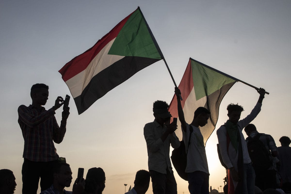 A group of people stage a demonstration call for the disbanding of Sudan's former ruling National Congress Party (NCP), which was headed by ousted President Omar al-Bashir, on 21 October, 2019 in Khartoum, Sudan [Mahmoud Hajaj/Anadolu Agency]