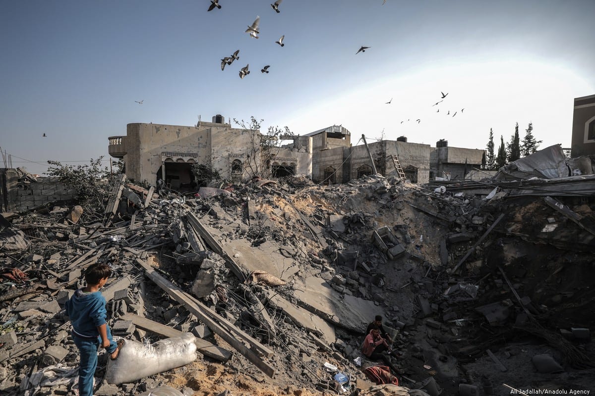Palestinians search for loved ones after Israeli air strikes hit their homes in Gaza on 14 November 2019 [Ali Jadallah/Anadolu Agency]