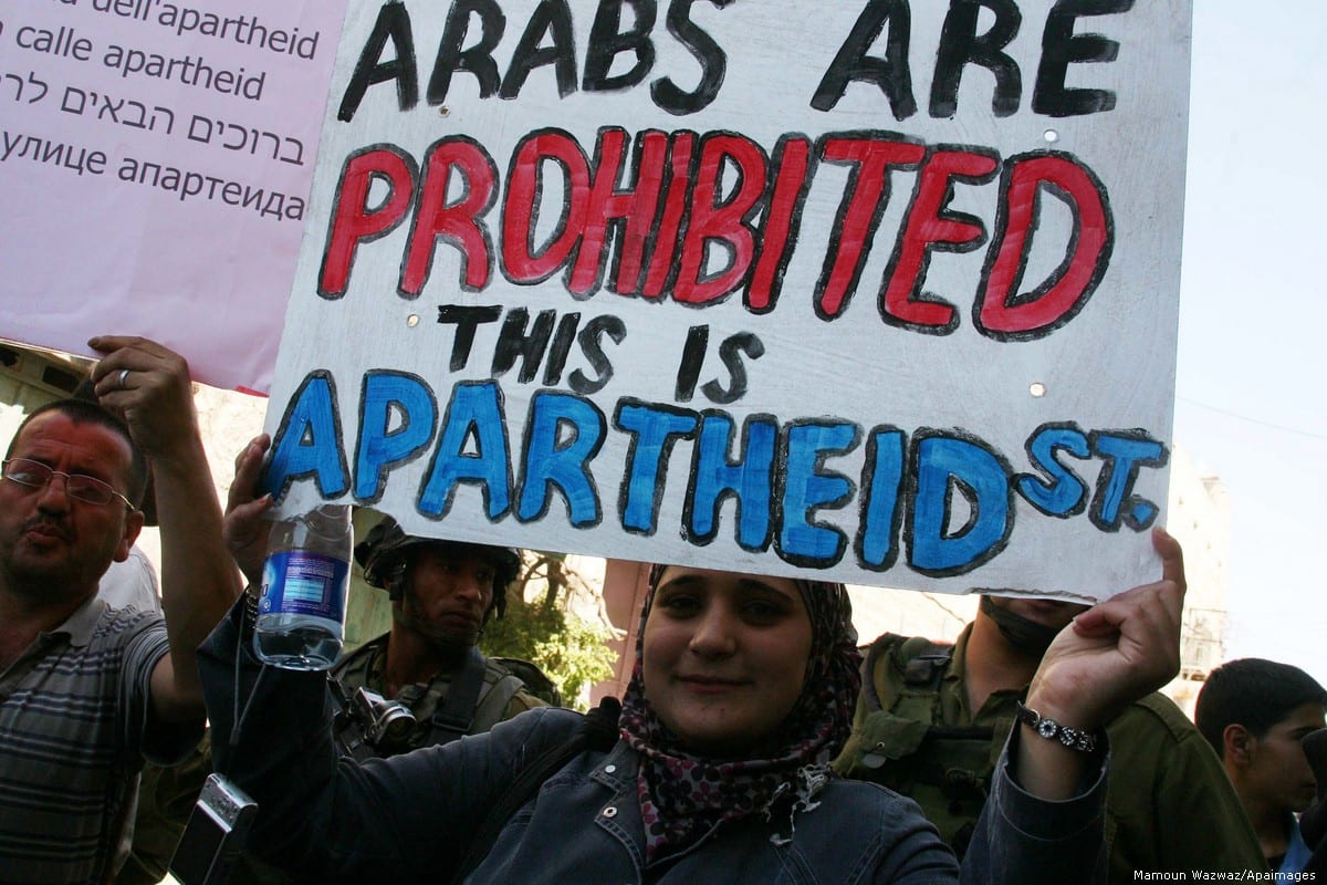 Palestinians take part in a rally against apartheid in the West Bank town of Hebron on 14 September 2012 [Mamoun Wazwaz/Apaimages]