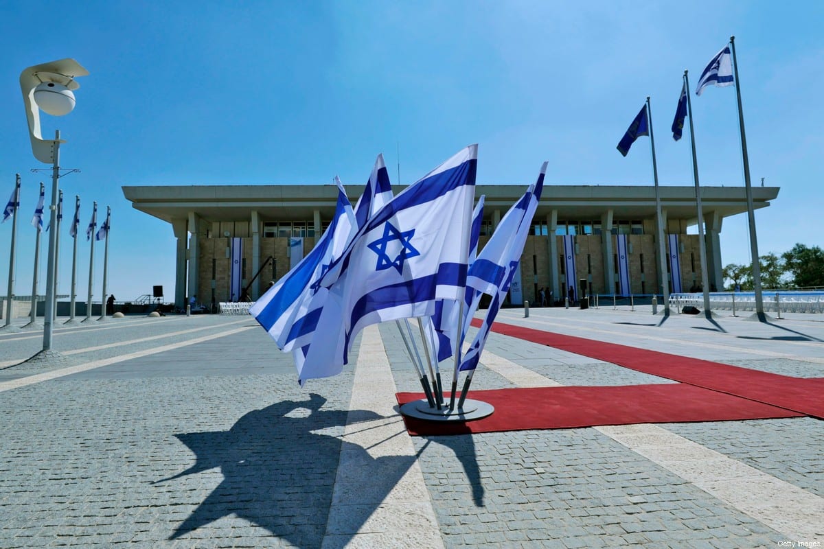This picture taken on October 3, 2019 shows Israeli flags flying outside the Knesset (Israeli parliament) headquarters in Jerusalem [EMMANUEL DUNAND/AFP via Getty Images]
