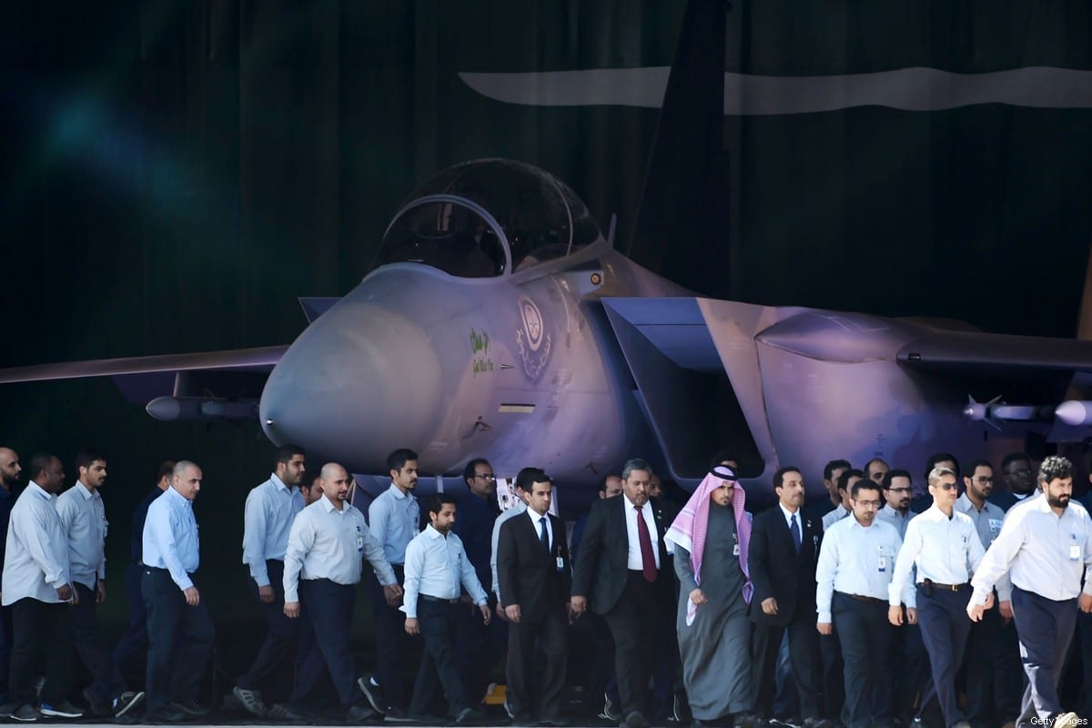 Saudi Air Force officers and technical staff walk past an advanced F-15SA fighter jet during ceremony marking the 50th anniversary of the creation of the King Faisal Air Academy at King Salman airbase in Riyadh [FAYEZ NURELDINE/AFP via Getty Images]