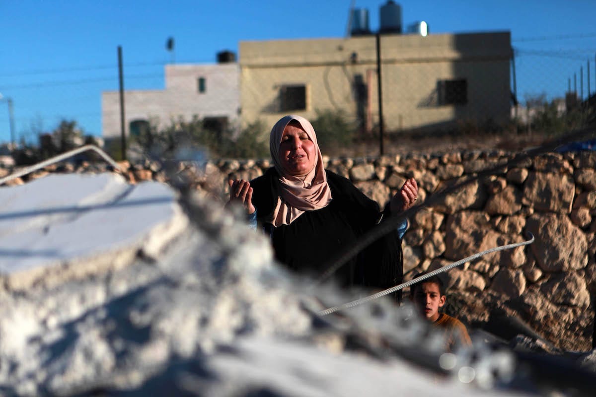 A Palestinian woman cries at debris of a building after Israeli forces demolished houses of 4 Palestinians, accused of killing an Israeli soldier, at Beit Kahil village in Hebron, West Bank on 28 November 2019. [Mamoun Wazwaz - Anadolu Agency]