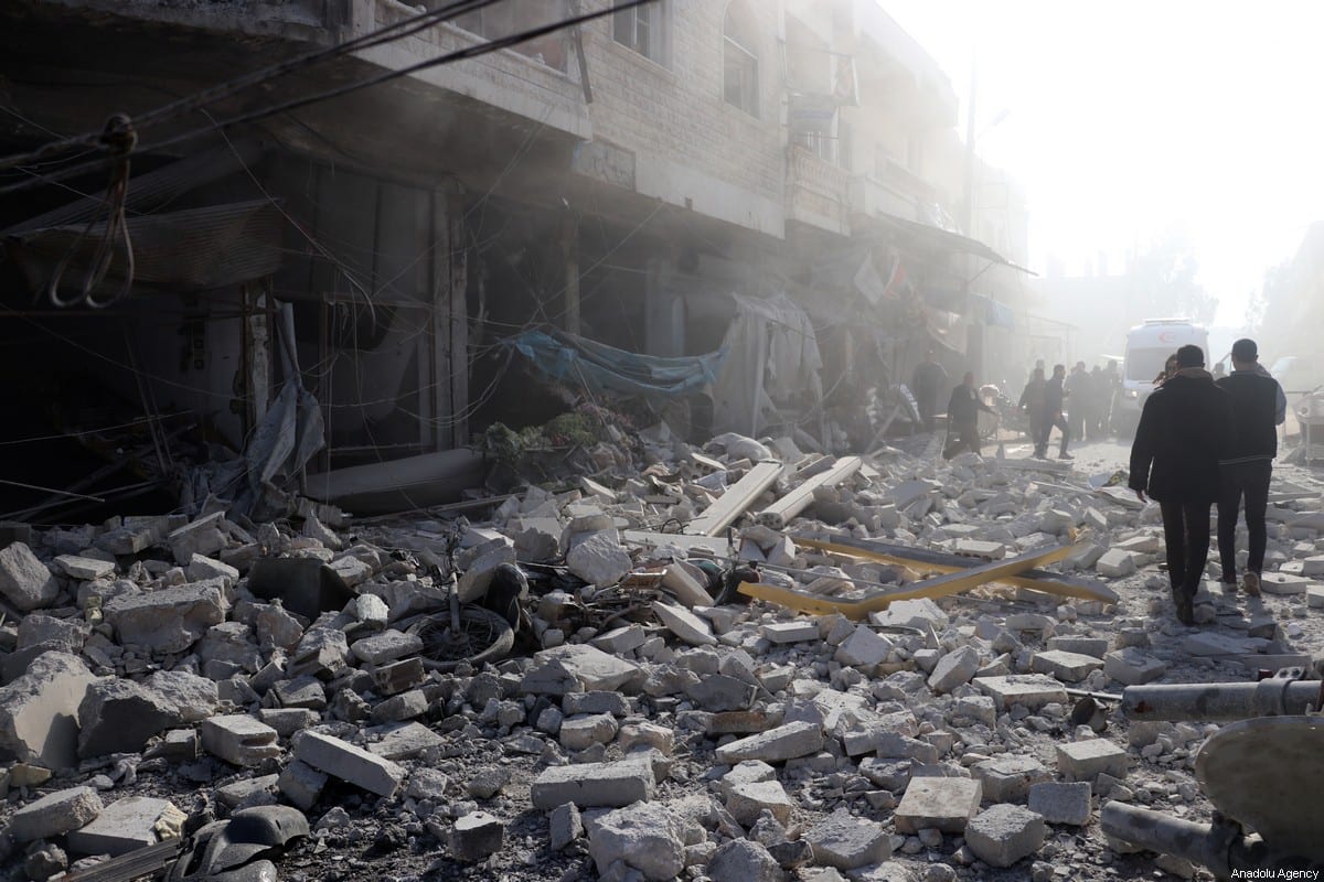 Civil defence crews and locals conduct search and rescue operations around wreckage of buildings after airstrikes carried out by Assad Regime over Saraqib district in the de-escalation zone of Idlib, Syria on 21 December 2019 [Hüseyin Fazıl / Anadolu Agency]