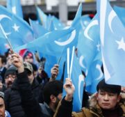 Demonstrators hold Uyghur flags as they take part in a demonstration in support of Uyghur Turks against human rights violations of China, in Berlin, Germany on 27 December 2019. [Abdulhamid Hoşbaş - Anadolu Agency]