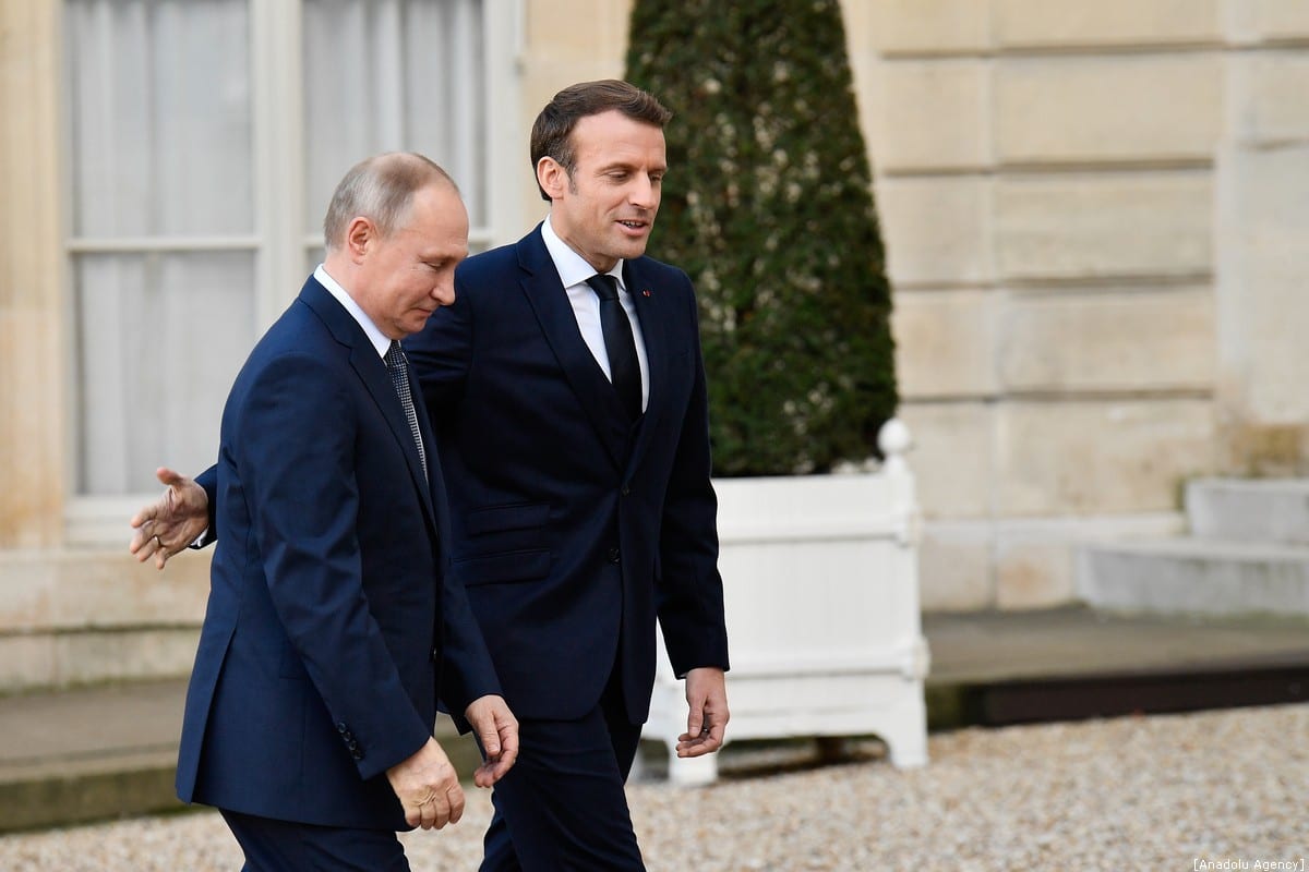French President, Emmanuel Macron (R) welcomes Russian President Vladimir Putin (L) ahead of Normandy Four Summit at the Elysee Palace in Paris, France on December 9, 2019. [Julien Mattia - Anadolu Agency]