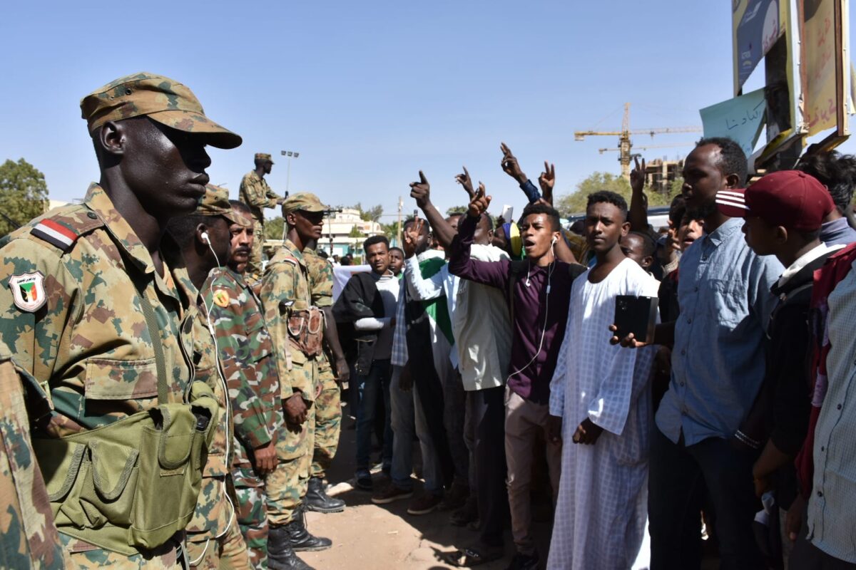 Sudanese demonstrators carry placards and chant slogans as they protest outside the Foreign Ministry in the capital Khartoum on 28 January, 2020 [Mahmoud Hajaj/Anadolu Agency]