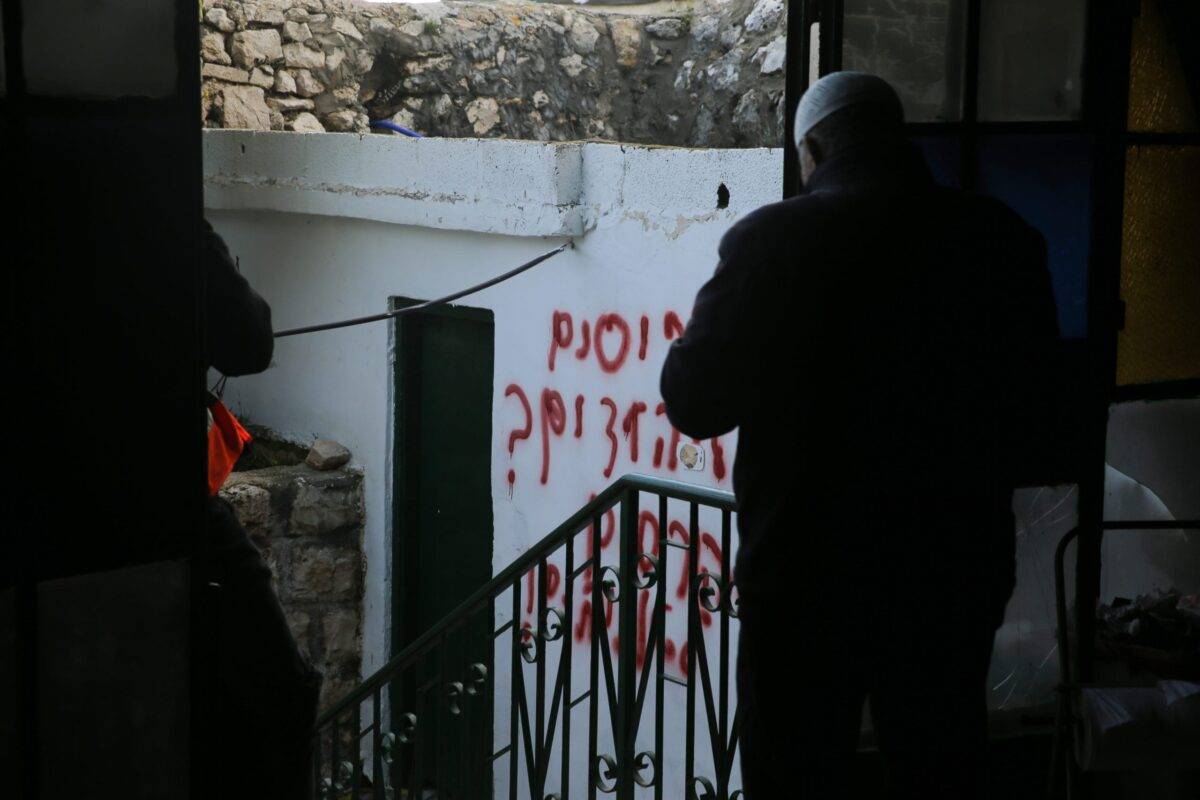 Racial slurs on the wall of a mosque sprayed by settlers in Jerusalem on 24 January 2020 [Mostafa Alkharouf/Anadolu Agency]