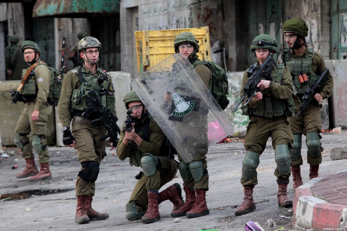 Israeli forces take aim at Palestinians during a protest against US President Donald Trump’s Middle East plan in Hebron, West Bank on January 31, 2020 [Mamoun Wazwaz / Anadolu Agency]