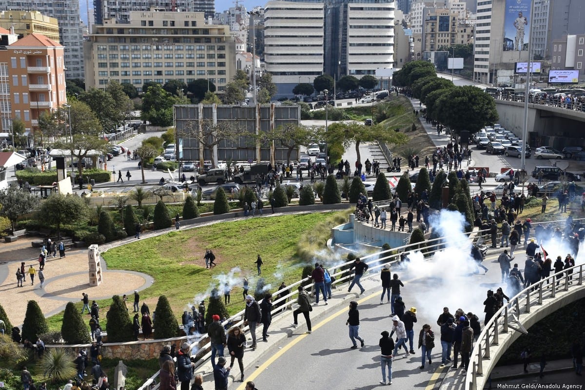 Lebanese security forces clash with protesters during a protest held before a session at a parliament for a vote of confidence to new government of Hassan Diab on February 11, 2020 in Beirut, Lebanon [Mahmut Geldi/ Anadolu Agency]