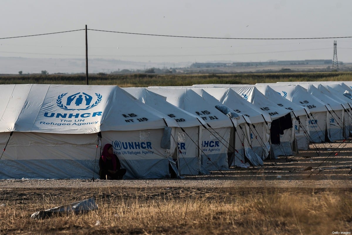 A refugee woman sits next to a tent in Nea Kavala camp, near the city of Kilkis, northern Greece, on September 3, 2019. [SAKIS MITROLIDIS/AFP via Getty Images]