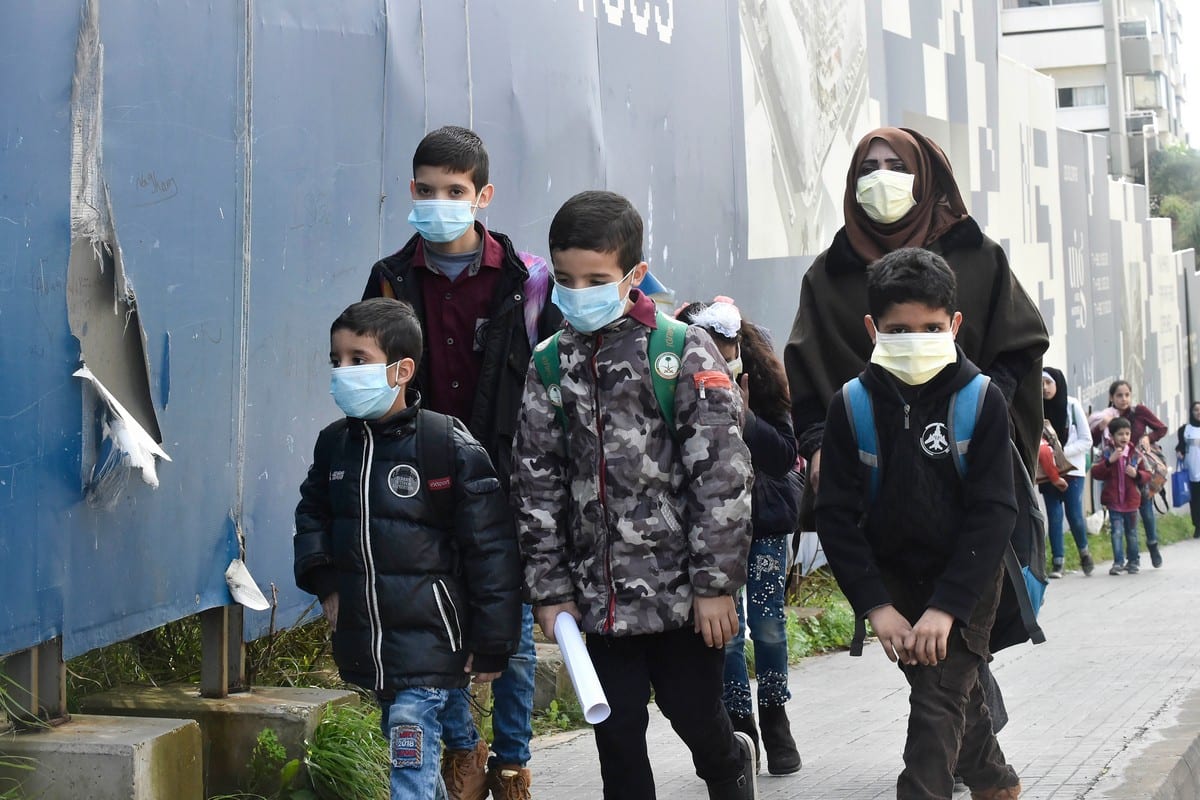 Students wear masks to protect themselves from coronavirus as a precaution in Beirut, Lebanon on 22 February 2020 [Hussam Chbaro/Anadolu Agency]