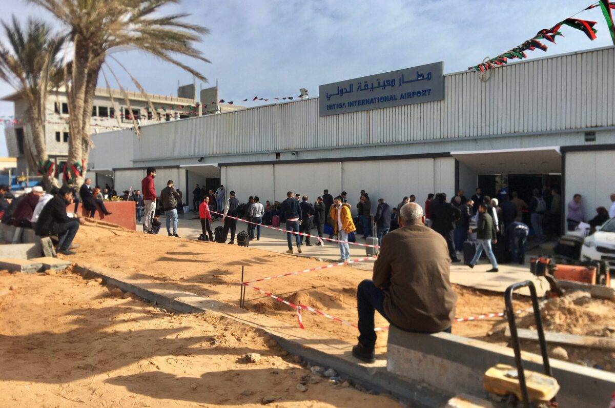 People wait in front of Mitiga International Airport in Tripoli, Libya on 27 February 2020 [Hazem Turkia/Anadolu Agency]