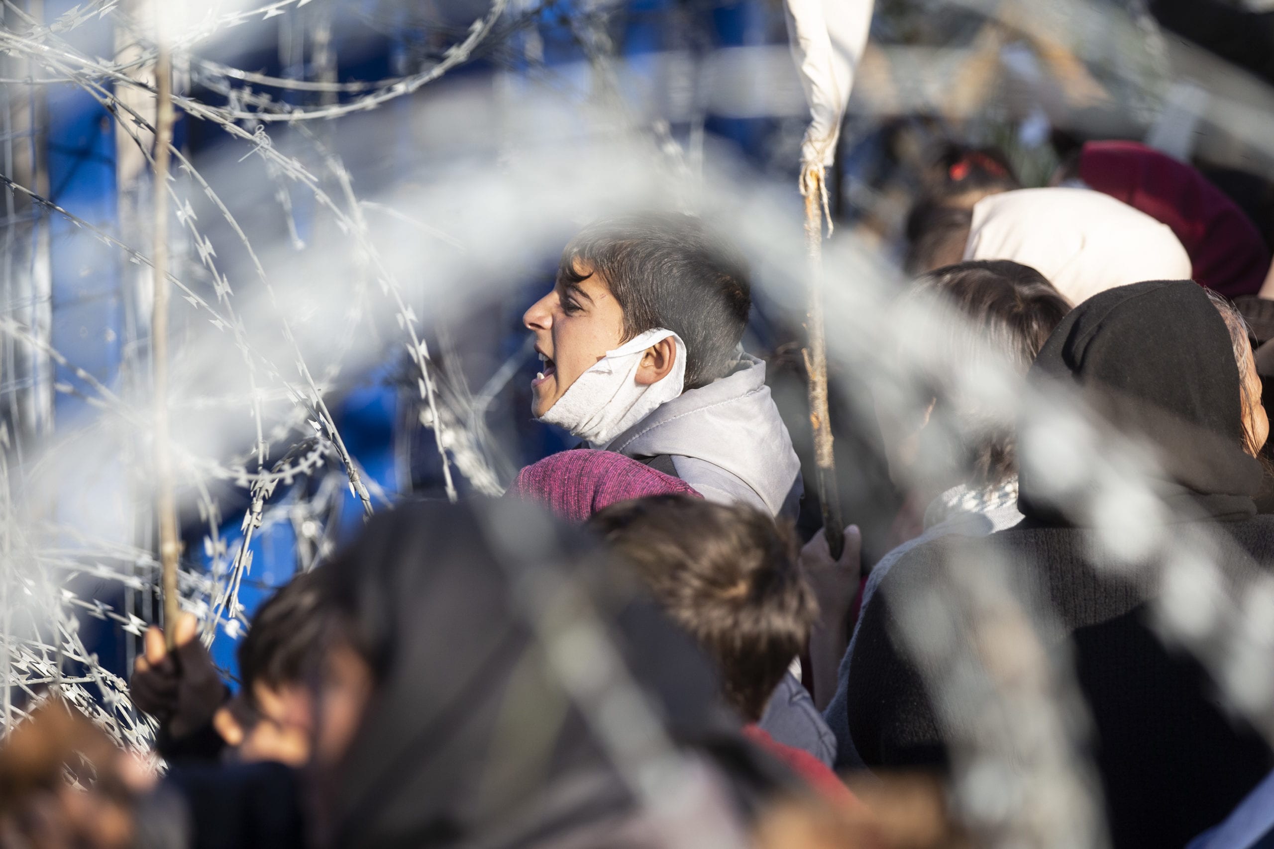 Refugees are seen waiting at the buffer zone near the border gates in Greece on 14 March 2020 Gökhan Balcı/Anadolu Agency]