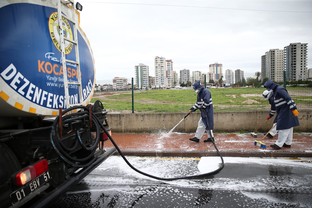 Municipality crews, wearing protective suits, disinfect public places as part of precautions against the coronavirus (COVID-19), in Adana, Turkey on 17 March 2020. [Eren Bozkurt - Anadolu Agency]