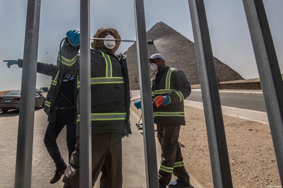 Egyptian municipality workers disinfect the Giza pyramids as protective a measure against the spread of the coronavirus on 20 March 2020 [KHALED DESOUKI/AFP/Getty Images]