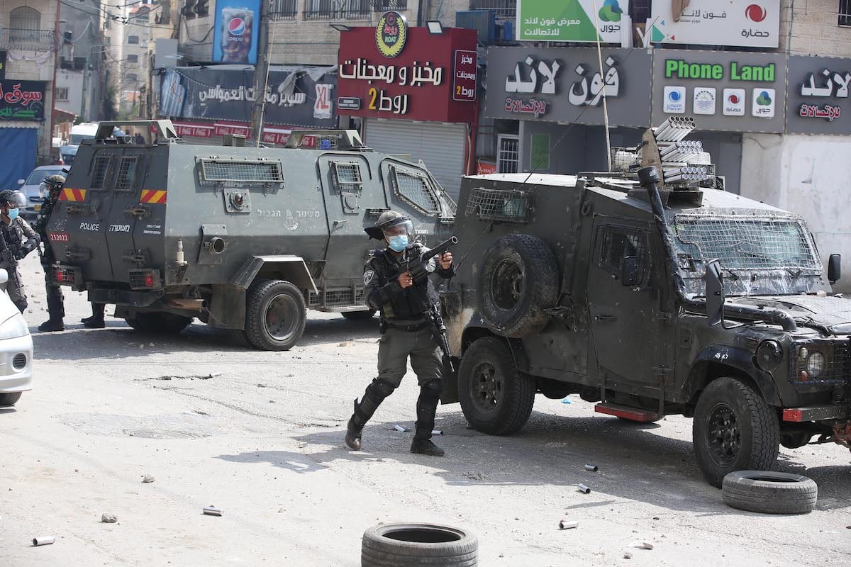 Israeli soldiers use tear gas to disperse the Palestinians reacting against the raid on Kalandia Camp in Ramallah, West Bank on April 14, 2020 [Issam Rimawi - Anadolu Agency]