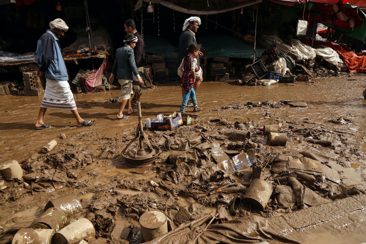 Yemenis inspect damaged area following heavy rains and floods in Sanaa, Yemen, on 14 April 2020. [Mohammed Hamoud - Anadolu Agency]