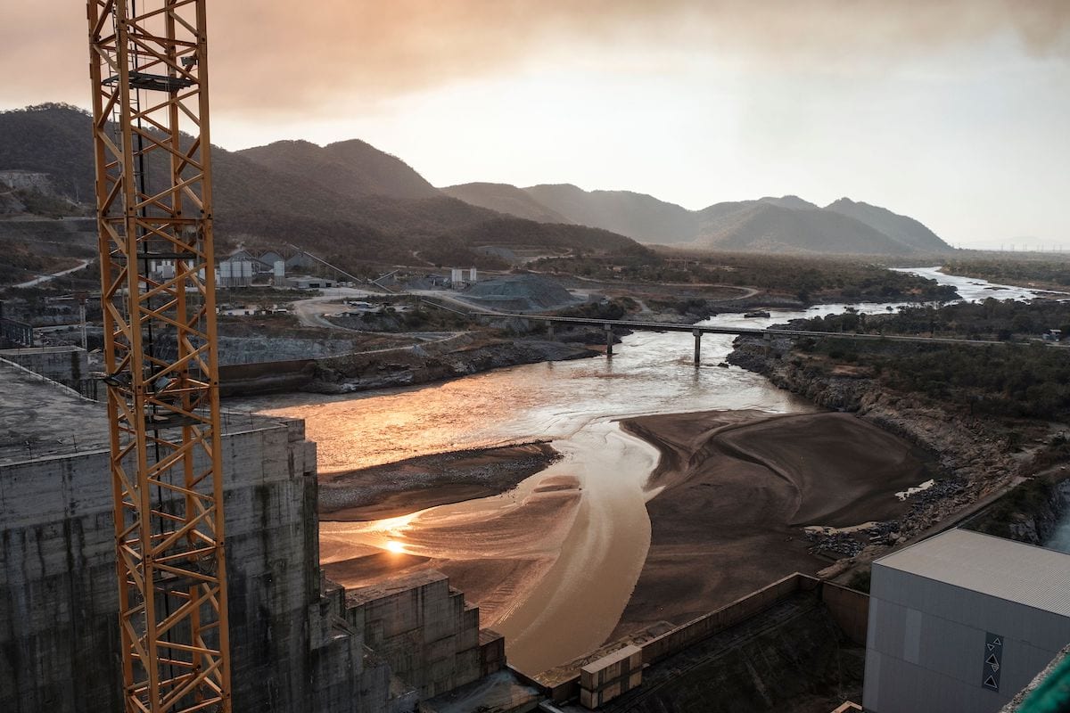 A general view of the Blue Nile river as it passes through the Grand Ethiopian Renaissance Dam (GERD), near Guba in Ethiopia, on 26 December 2019. - The Grand Ethiopian Renaissance Dam, a 145-metre-high, 1.8-kilometre-long concrete colossus is set to become the largest hydropower plant in Africa. Across Ethiopia, poor farmers and rich businessmen alike eagerly await the more than 6,000 megawatts of electricity officials say it will ultimately provide. Yet as thousands of workers toil day and night to finish the project, Ethiopian negotiators remain locked in talks over how the dam will affect downstream neighbours, principally Egypt. [EDUARDO SOTERAS/AFP via Getty Images]