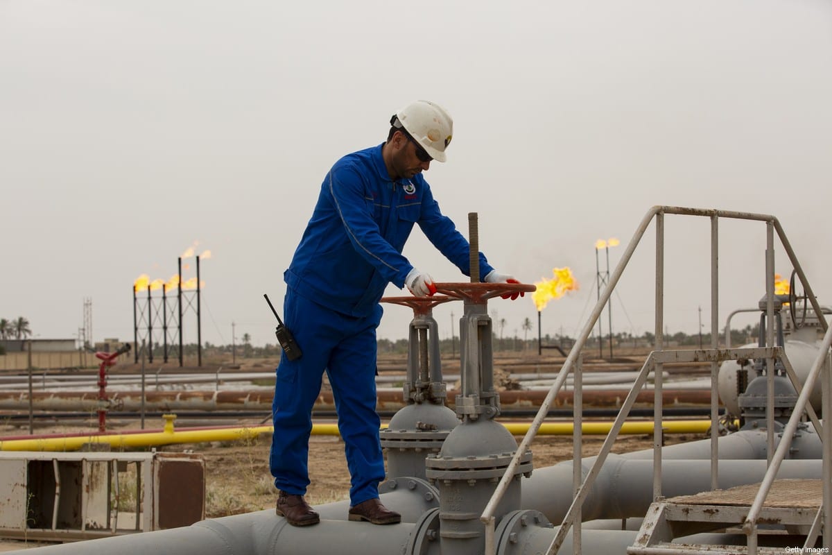 An employee turns a valve at the Nahr Bin Omar natural gas field, north of the southern Iraqi port of Basra on April 21, 2020. (Photo by Hussein FALEH / AFP) (Photo by HUSSEIN FALEH/AFP via Getty Images)