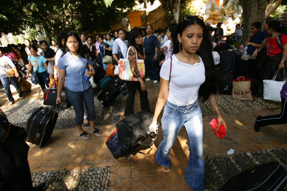 Filipino nationals gather at the French embassy in Beirut before their evacuation from war-torn Lebanon, 23 July 2006 [NICOLAS ASFOURI/AFP via Getty Images]