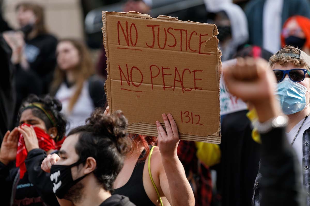 People carrying banners march to protest over the death of George Floyd an unarmed black man who died after being pinned down by a white police officer in USA on 31 May 2020 in Portland, Oregon. [John Rudoff - Anadolu Agency]