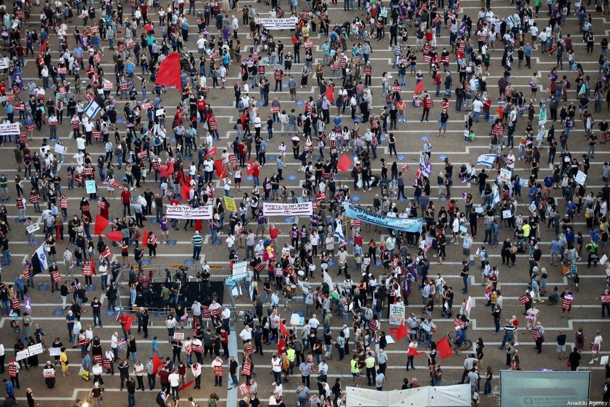 Israelis gather to stage a demonstration, while observing social distancing, to protest against Israel's annexation plan for the illegal settlements in West Bank and Jordan Valley, in Tel Aviv, Israel on June 6, 2020 [Nir Keidar / Anadolu Agency]
