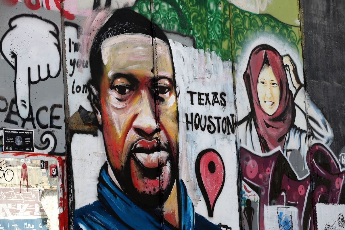 Portrait of George Floyd, a 46-year-old unarmed black man who was killed after a police officer knelt on his neck for nearly nine minutes, is painted on Israel's separation wall in the West Bank town of Bethlehem on June 8, 2020 [Wisam Hashlamoun - Anadolu Agency]