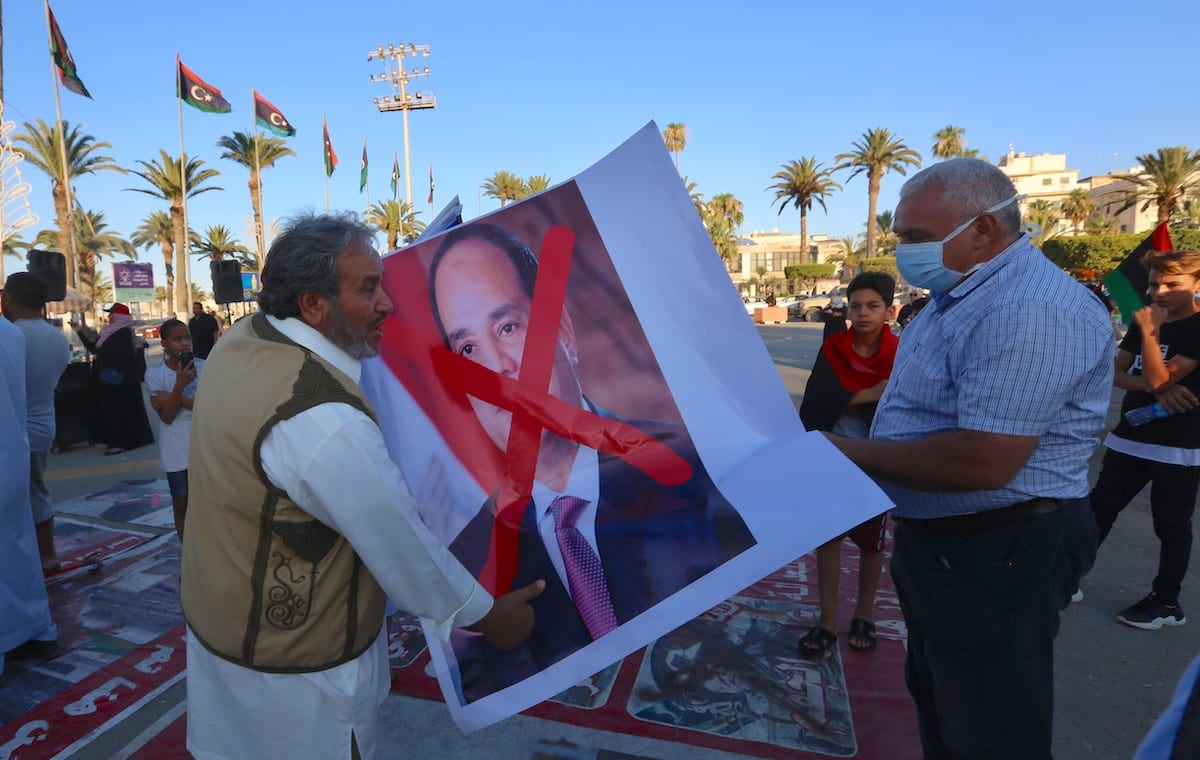 People carry a crossed out image of President of Egypt Abdel-Fattah Al-Sisi during a protest against him following his intervention threat at Martyrs Square in Tripoli, Libya on 21 June 2020. [Hazem Turkia - Anadolu Agency]