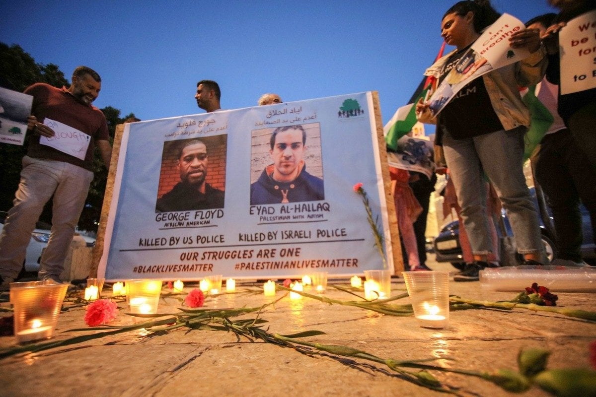 Palestinians in Gaza show solidarity with the Eyad Hallaq, an autistic Palestinian man who was shot dead by Israeli police and with US protesters following the death of George Floyd who was killed by a white police officer by pinning him to the ground, 2 June 2020 [Abedalrahman Hassan/ApaImages]