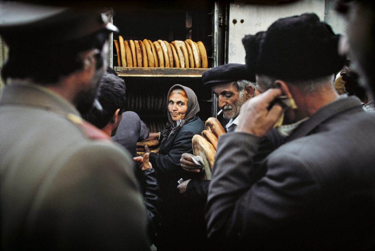 Azerbaijanis wait in line for the distribution of rationed bread and food to bring home to their families in Shusha, Azerbaijan, in May 1992. The city of Shusha was the last major town in Azerbaijan to fall to Armenian troops. Shusha was the historical and cultural center of the Karabakh region and Azerbaijans last strategic foothold. After being under siege for many months, on May 8, 1992, the Armenian military launched their operation to capture the city. They attacked from three sides, trapping Azerbaijani military units and civilians on their hilltop. For hours Armenian armed forces shelled the town, killing and wounding hundreds of men, women and children. After capturing the town, marauders and vandals burnt major cultural sites, museums, mosques, and schools. [ Reza/Getty Images]