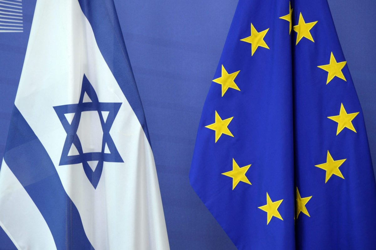 An Israeli flag is set next to a European Union flag at the European Union Commission headquarters in Brussels on June 23, 2016 [THIERRY CHARLIER/AFP via Getty Images]