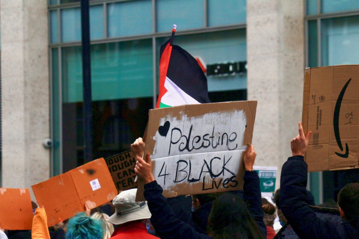 A protestor holds up a "Palestine 4 Black Lives" placard at the Black Lives Matter protests in London, UK on 7 June 2020 
[Lauren Lewis/Middle East Monitor]